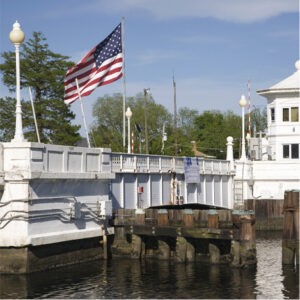 an american flag is flying over a bridge
