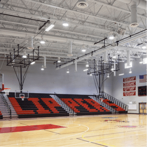 an empty gym with red and black seats