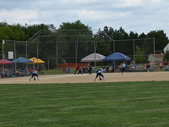 a group of people on a field playing baseball