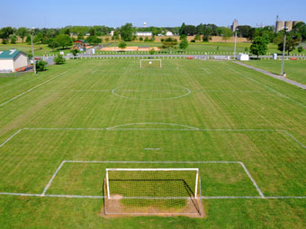 an aerial view of a soccer field and goal