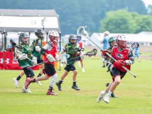 a group of young men playing a game of lacrosse