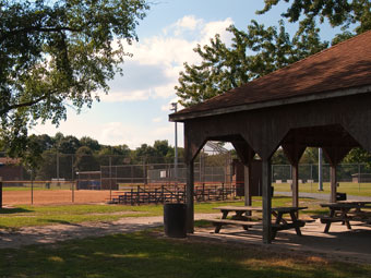a park with picnic tables and a pavilion