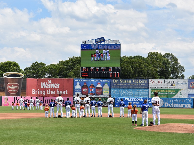 a group of baseball players standing on top of a field