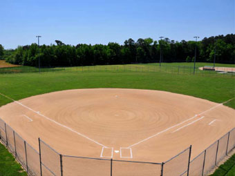 an empty baseball field with a fence around it