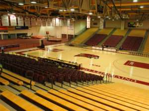 an empty basketball court with rows of seats