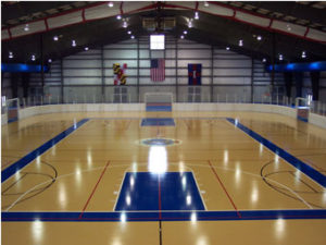 an indoor basketball court with blue and yellow lines
