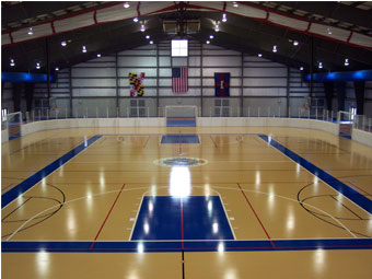 an indoor basketball court with blue and yellow lines