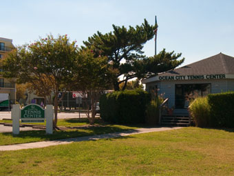 a sign in front of a building that says ocean city tennis center